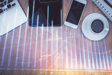 Multi exposure of forex graph hologram over desktop with phone. Top view. Mobile trade platform...