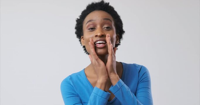 African American woman shouting with hands cupped around mouth