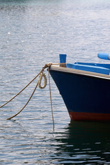 Small blue boat in the port. Selective focus, close-up.
