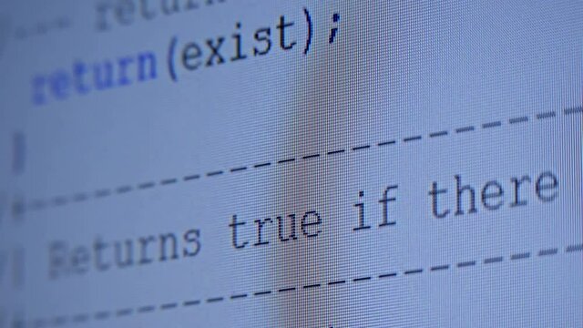 Lines of programmes code run across the white screen. Hacker tries to break security and commit data theft. Closeup