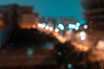 Rain window autumn park branches leaves yellow . Abstract autumn background, landscape in a rainy window, weather October rain