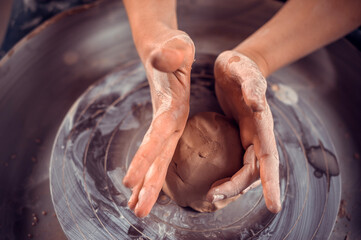 Master class on modeling of clay on a potter's wheel In the pottery workshop