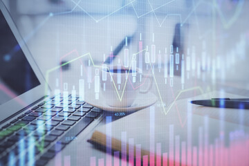 Double exposure of financial chart drawing and desktop with coffee and items on table background. Concept of forex market trading