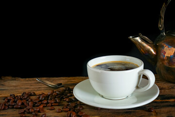 Hot coffee in a white cup on a wooden table