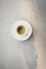 Dark Coffee in White Cup Espresso Morning Beverage Beautiful Shine Light and Shadow Marble Table Background Top View Flat Lay Minimalism