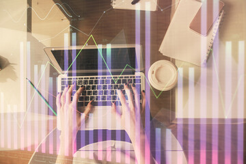 Fototapeta na wymiar Double exposure of woman hands working on computer and forex chart hologram drawing. Top View. Financial analysis concept.