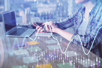 Double exposure of businesswoman hands typing on computer and forex graph hologram drawing. Financial analysis concept.