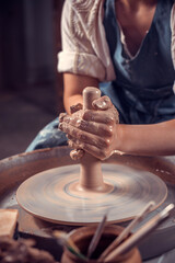 The hands of the master who makes the jug. Close-up.