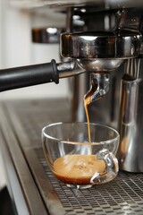 Professional coffee machine making espresso in a cafe