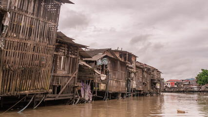 Wooden house on Karang Mumus Riverbank. Slum area on Karang Mumus river, Samarinda, Indonesia