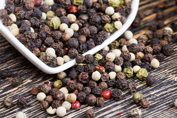 black peas pepper on an old wooden table
