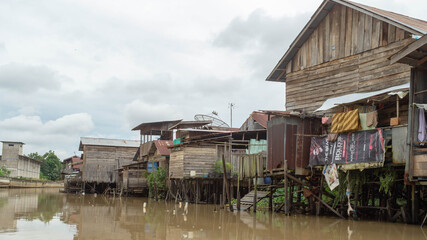 Wooden house on Karang Mumus Riverbank. Slum area on Karang Mumus river, Samarinda, Indonesia