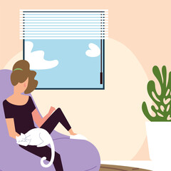 woman with cat sitting on bean chair in the room