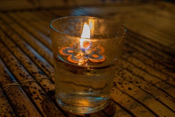 Worm candelar on wood table background, scene from Bali, Indonesia 