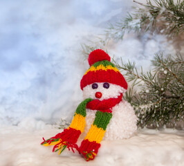 snowmen made with wool pompoms, on a Christmas background