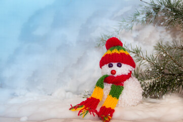 snowmen made with wool pompoms, on a Christmas background