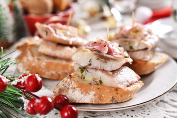 mini canapes with herring and pickled ginger and onion in oil for Christmas