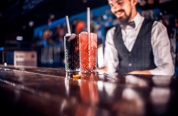 Focused barman surprises with its skill bar visitors at bar