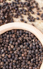 spice black pepper scattered on an old wooden table