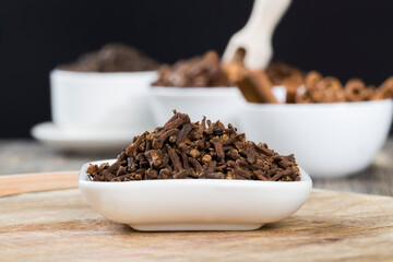 spices of cloves scattered on an old wooden table