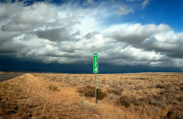 Remote US highway mile marker and approaching storm.