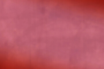 Blurred background in pink red color with copy space for web design and wallpaper. Abstract blur background in red color with shade vignette. 