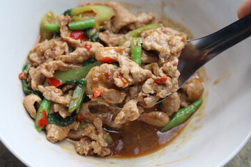 Popular street food in Thailand. Stir Fried Pork with Basil , Chili ,Bell Pepper and Long Bean or  Phat Gaphrao Muu  in Thai language. 