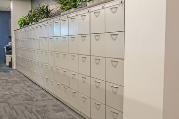 Row of white office filing cabinets.