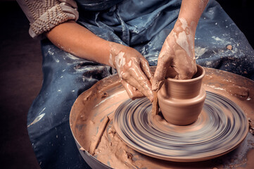Potter craftsman demonstrates the process of making ceramic dishes using the old technology....