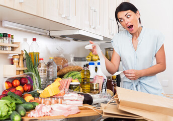 Adult woman is upset of check on food at home kitchen