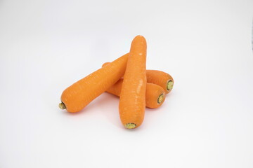 A pile of fresh carrots on a white background