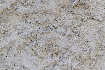 Obraz na płótnie Canvas Closeup of wall with gray cement roughcast, with irregular texture in masonry wall 