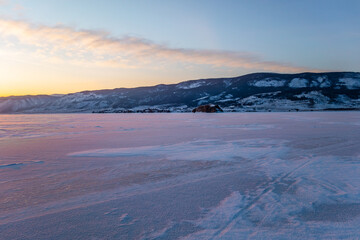 Fantastic sunset in winter on the ice of Lake Baikal, Siberia Russia. Winter season natural landscape.