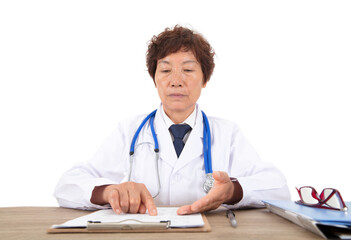 Chinese female doctor sitting at the table looking at the medical list