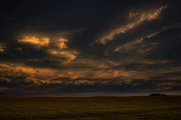 stormy sunset over field 