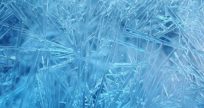 Frost covered window with lights shimmering and glittering over ice crystals. Seamless Loop.