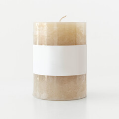 Beige pillar candle bulk on white background