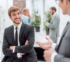 employees discuss their ideas standing in the office lobby