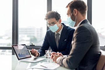 Office in new normal, men wearing medical mask covid 19