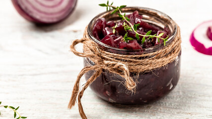 Homemade DIY natural healthy red onion marmalade jam, confiture, chutney in jar. Vegetable jam on white wooden background. French cuisine, Long banner format