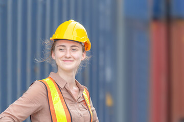Happiness Female engineer in hardhat and safety vest, Smiling factory worker woman at container cargo