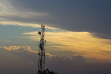 An evening view of the cloudy sky and a communication tower