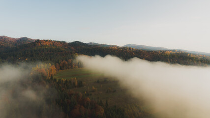 Landscape with fog and hills on an epic autumn morning