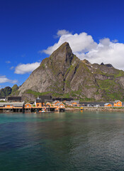 Sakrisøy Island with colorful yellow fishing houses in a sunny day, Lofoten, Norway