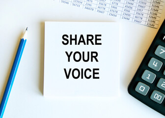 On the sheet for notes the text SHARE YOUR VOICE, next to the calculator, pencil and reports.