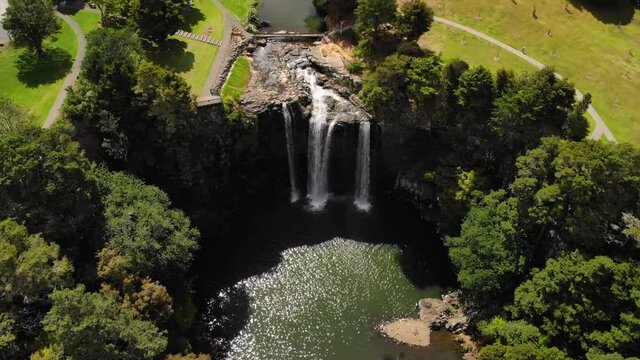 Spectacular curtain waterfall aerial look down shot. Whangarei Falls, New Zealand. Nice sunny day.