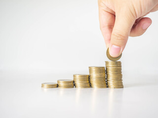 The hand was picking up the money that had been stacked up in layers. White background