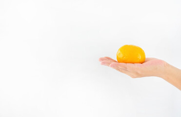 Man hand holding orange on white background