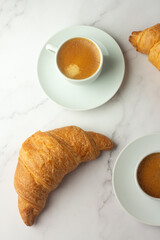 breakfast black coffee and croissants.