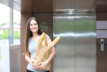 Fototapeta na wymiar woman holding breads in paper bag